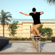 A skateboarding performing a 50-50 grind on a circle bar at some Cali-looking park.